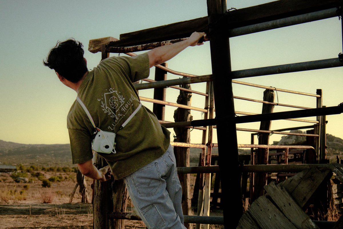 Photo showing a man wearing a green print on demand t-shirt in a desert setting.